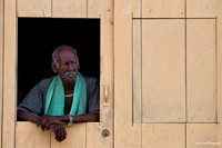 Man in Yellow Window